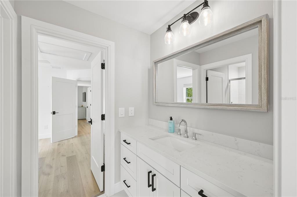 4013 Red Rock Lane Sarasota, FL 34231 - Photo 40 of 60 a bathroom with a sink vanity granite tub and a mirror