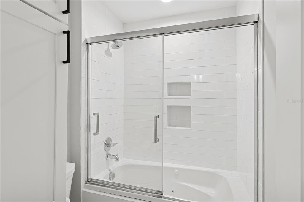 4013 Red Rock Lane Sarasota, FL 34231 - Photo 41 of 60 a bathroom with a glass shower door