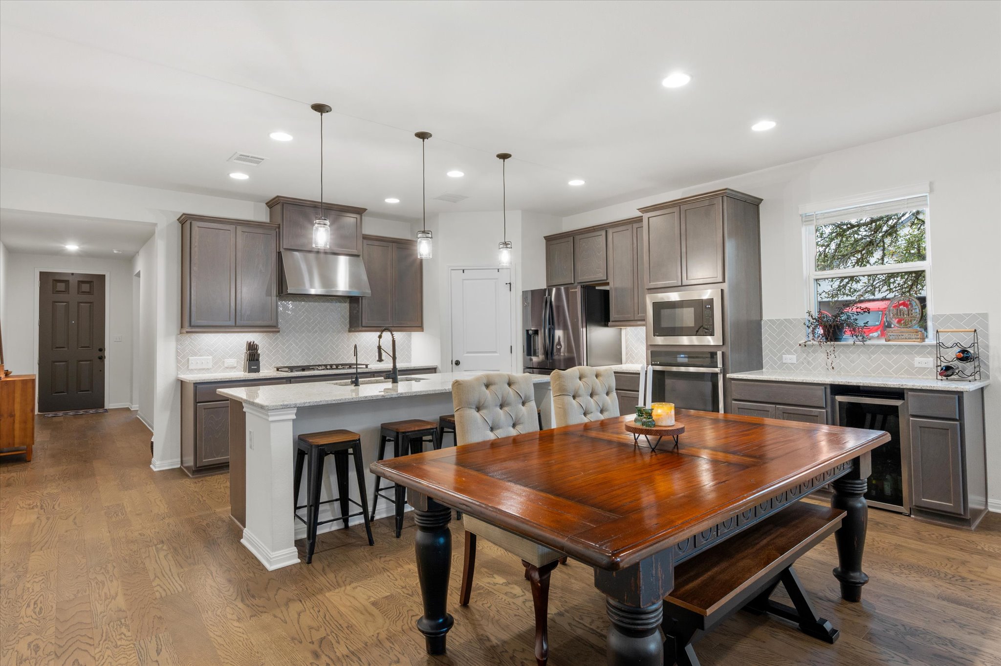 111 Beryl Way Dripping Springs, TX 78620 - Photo 1 of 26 a kitchen with a dining table chairs stove refrigerator and microwave