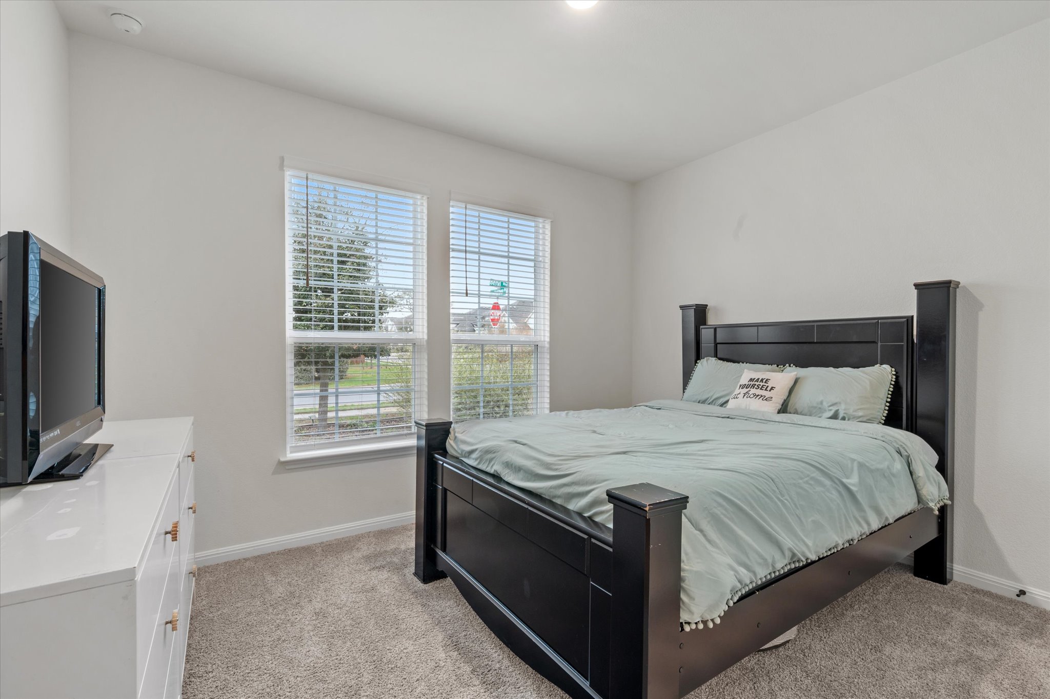 111 Beryl Way Dripping Springs, TX 78620 - Photo 12 of 26 a bed sitting in a bedroom next to a window