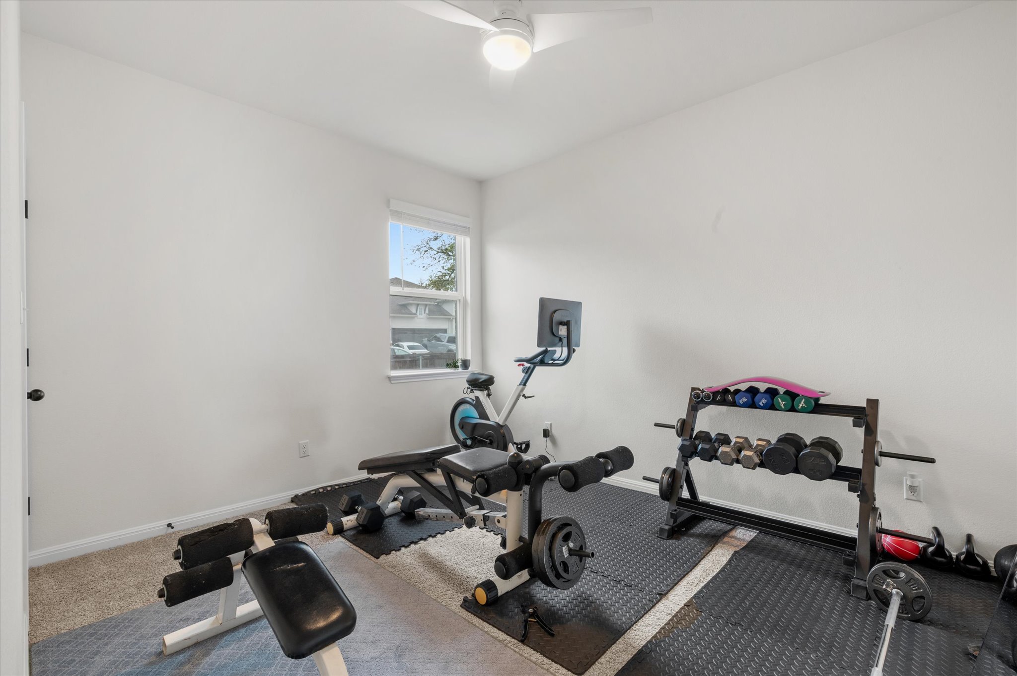 111 Beryl Way Dripping Springs, TX 78620 - Photo 15 of 26 a room with gym equipment and a view of living room