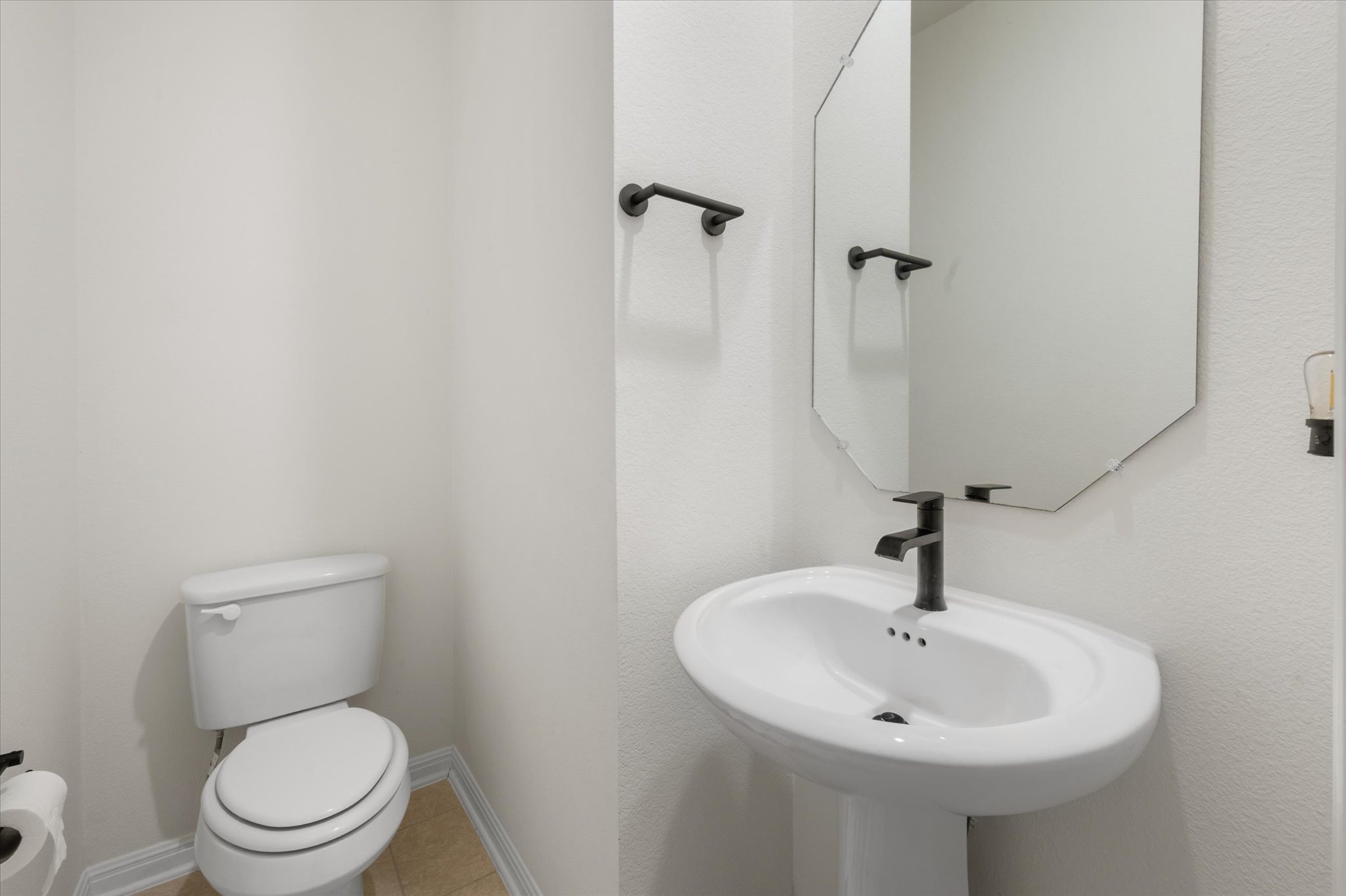 111 Beryl Way Dripping Springs, TX 78620 - Photo 16 of 26 a bathroom with a toilet sink and mirror