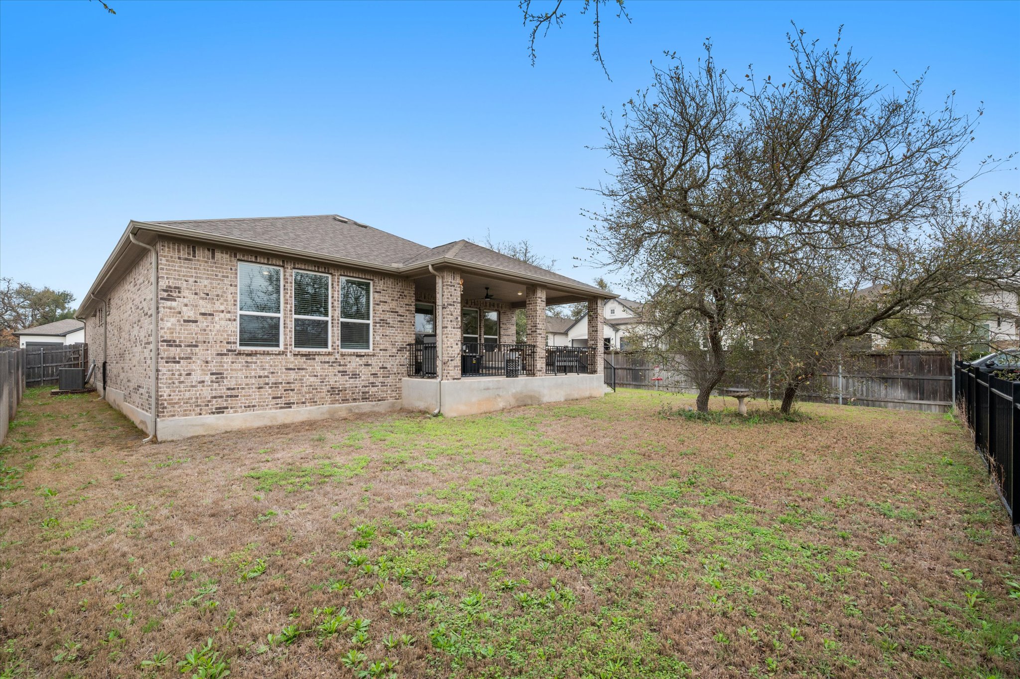 111 Beryl Way Dripping Springs, TX 78620 - Photo 20 of 26 a front view of a house with a garden and trees