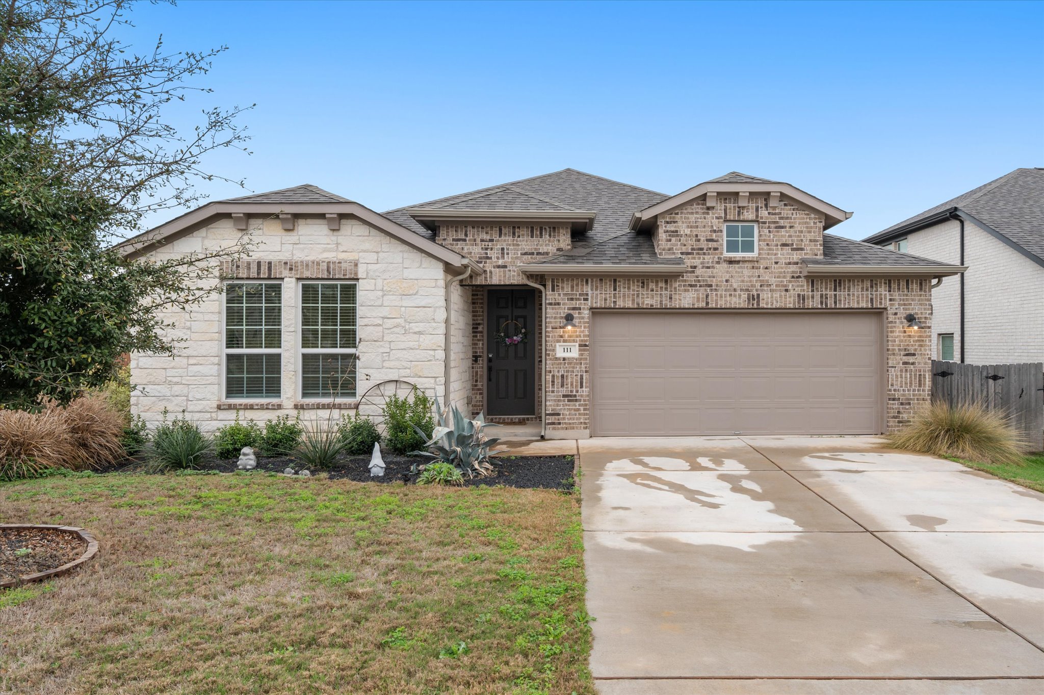 111 Beryl Way Dripping Springs, TX 78620 - Photo 2 of 26 a front view of a house with garden