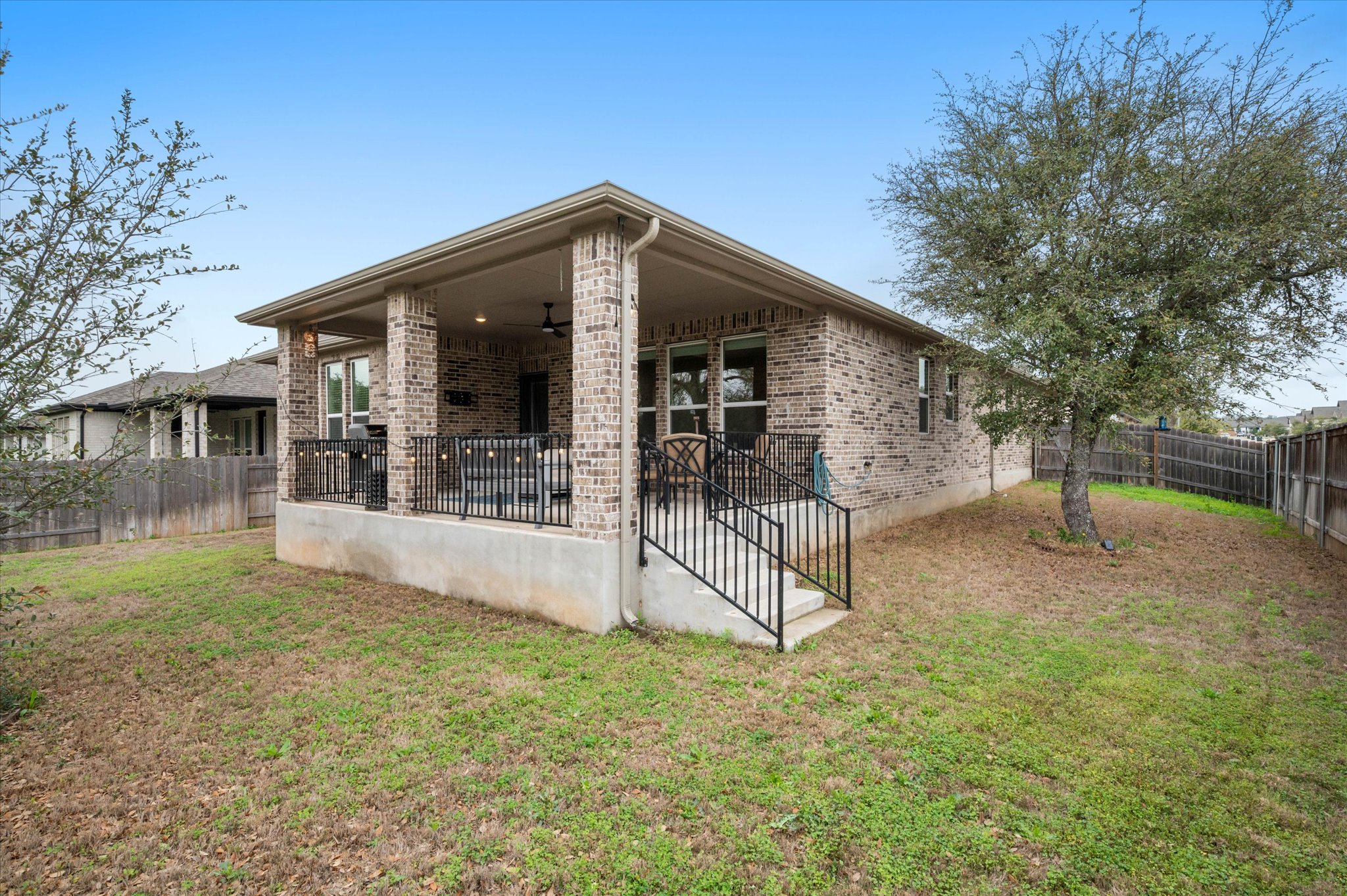 111 Beryl Way Dripping Springs, TX 78620 - Photo 21 of 26 a view of a house with backyard porch and sitting area
