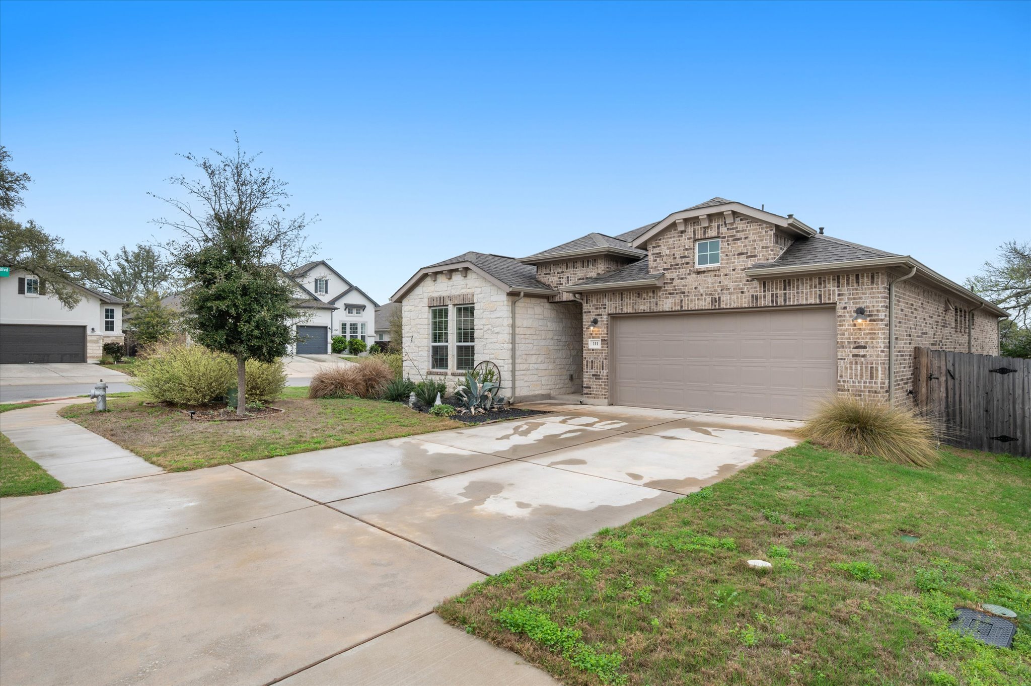 111 Beryl Way Dripping Springs, TX 78620 - Photo 22 of 26 a front view of a house with a garden and yard
