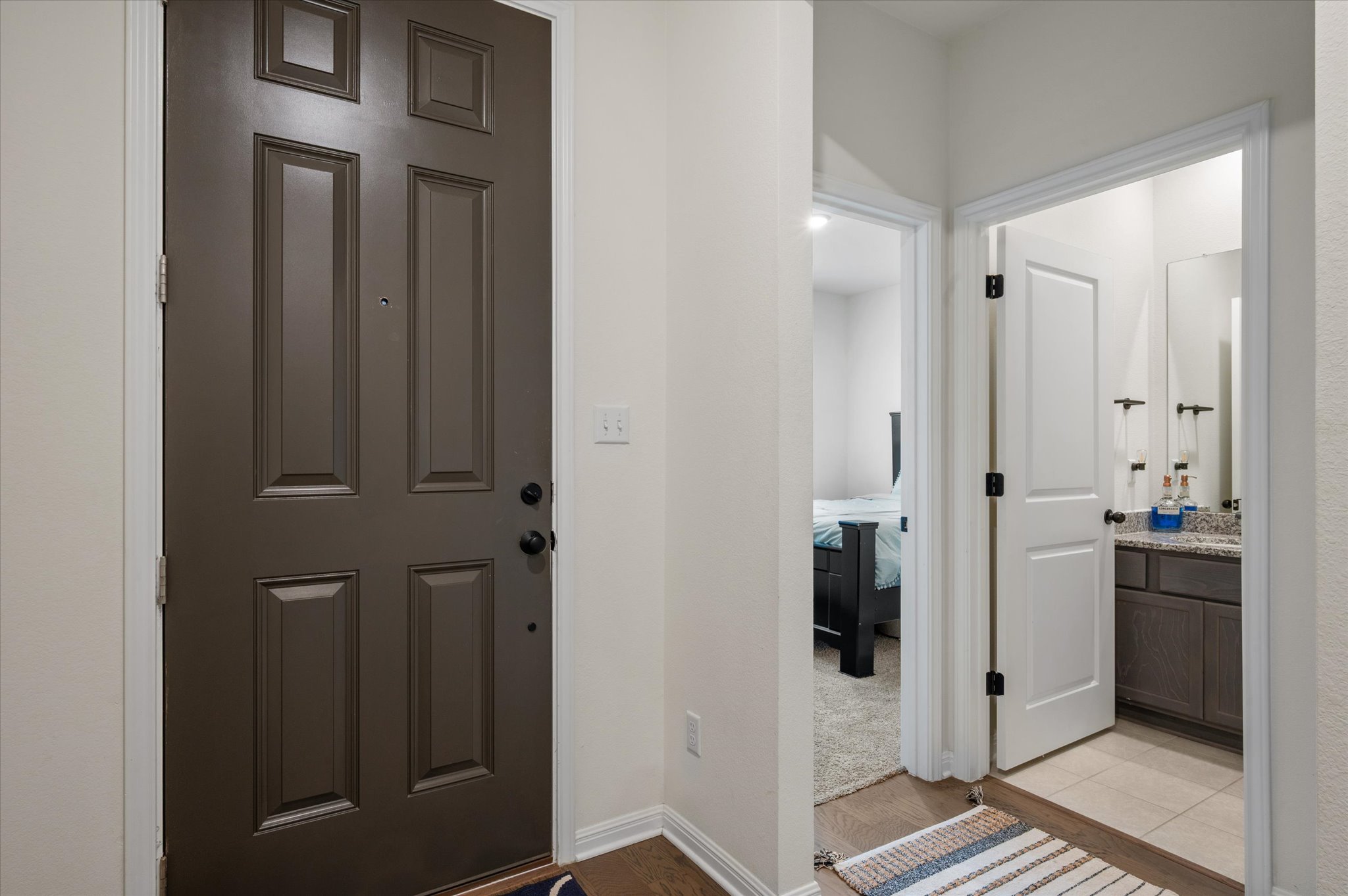 111 Beryl Way Dripping Springs, TX 78620 - Photo 3 of 26 a view of a hallway with wooden floor and closet area