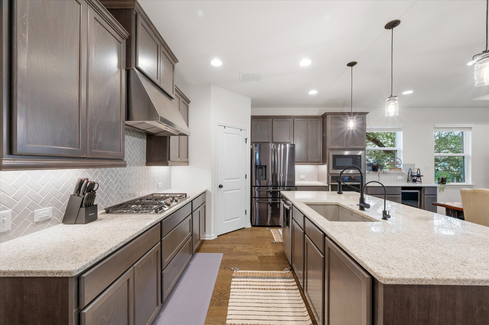 111 Beryl Way Dripping Springs, TX 78620 - Photo 4 of 26 a kitchen with stainless steel appliances granite countertop a sink a stove and a refrigerator