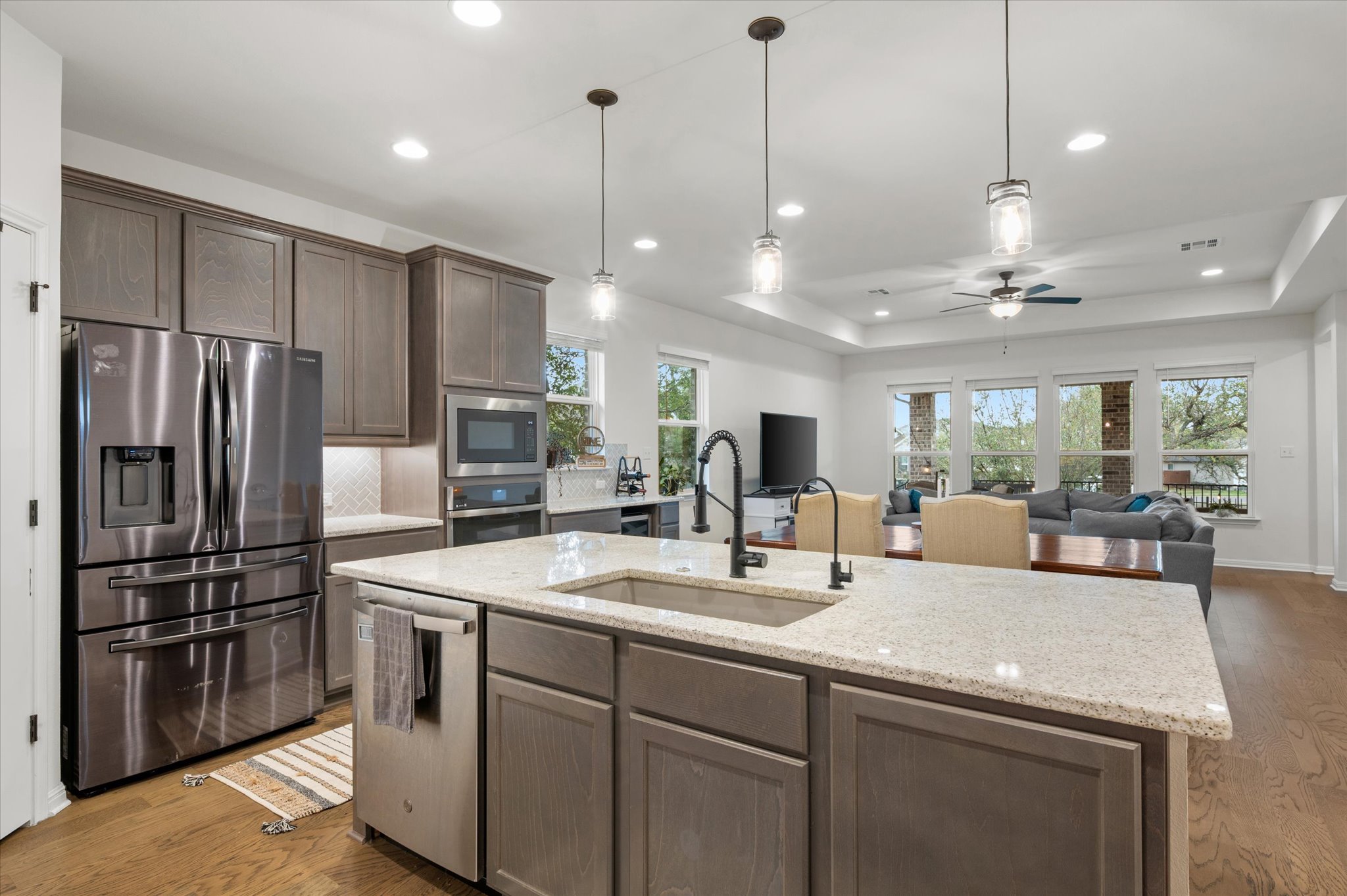 111 Beryl Way Dripping Springs, TX 78620 - Photo 5 of 26 a kitchen with stainless steel appliances granite countertop a refrigerator a sink and a refrigerator