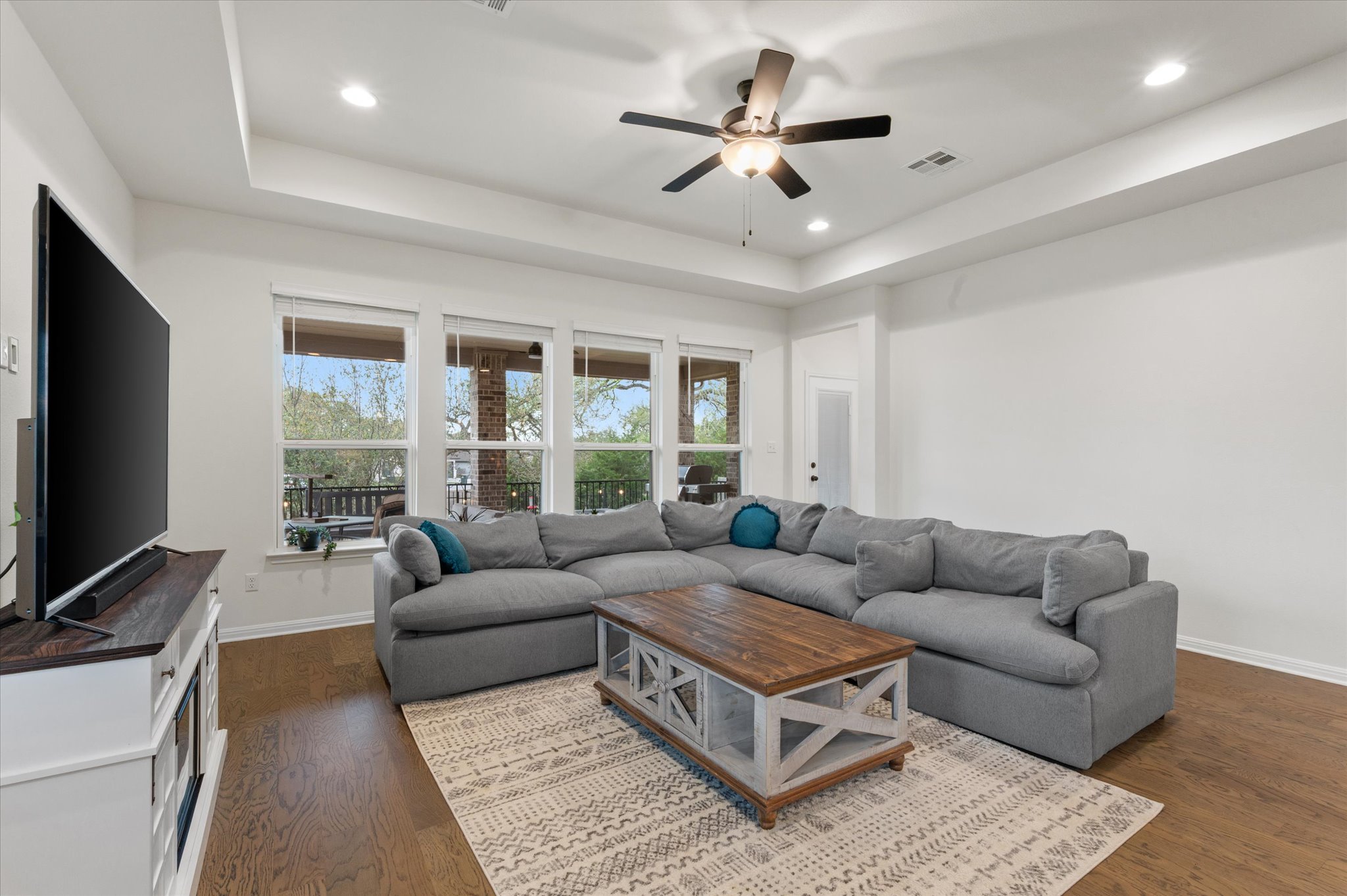 111 Beryl Way Dripping Springs, TX 78620 - Photo 7 of 26 a living room with furniture a large window and a flat screen tv