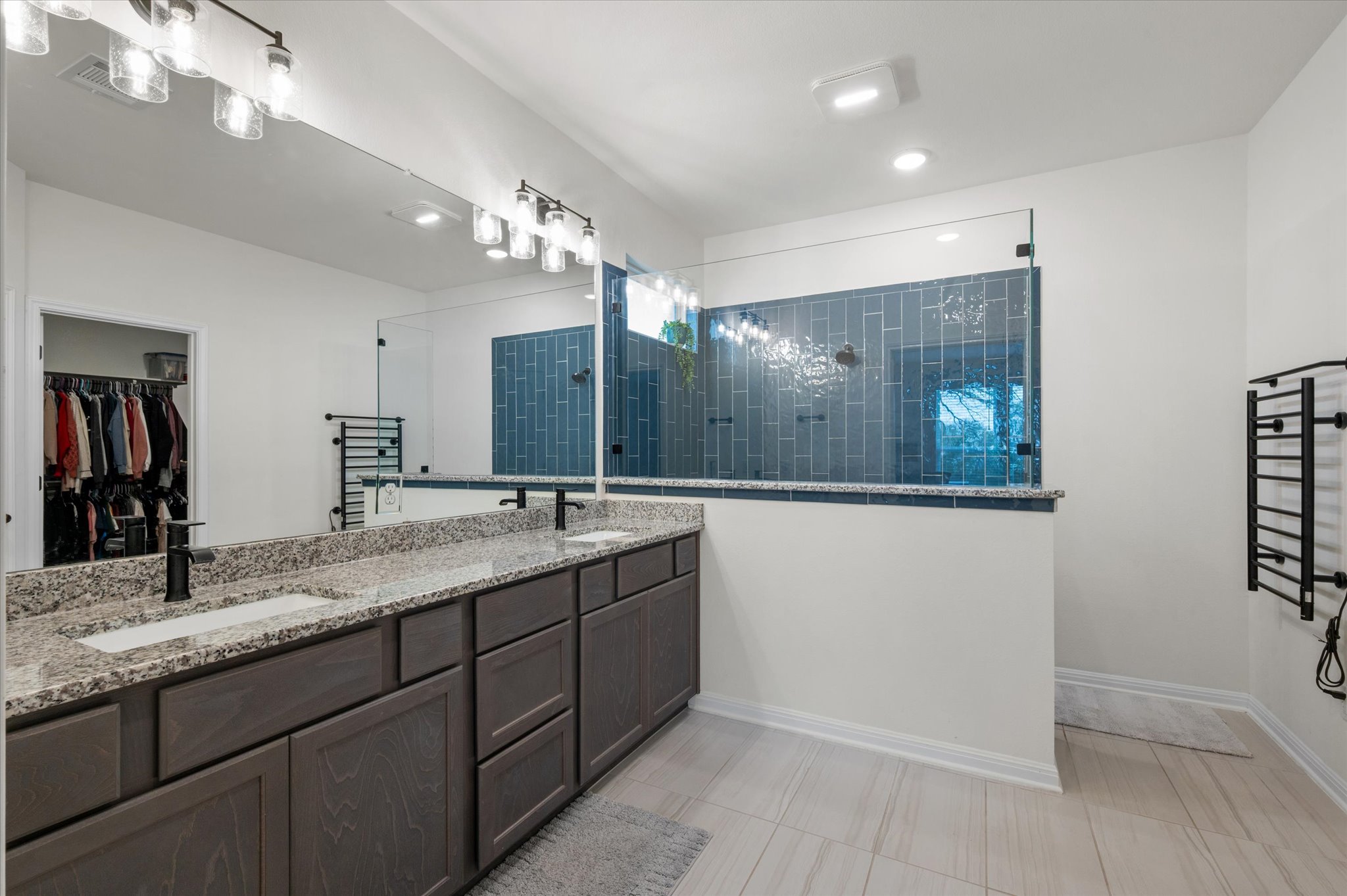 111 Beryl Way Dripping Springs, TX 78620 - Photo 10 of 26 a bathroom with a granite countertop sink a large mirror and a shower