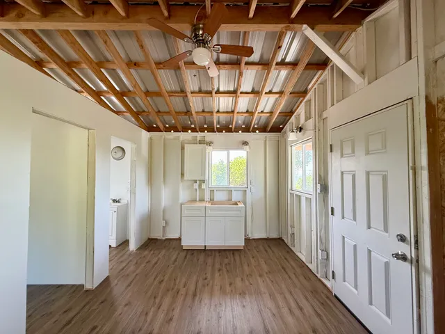 a room with wooden floors and white walls