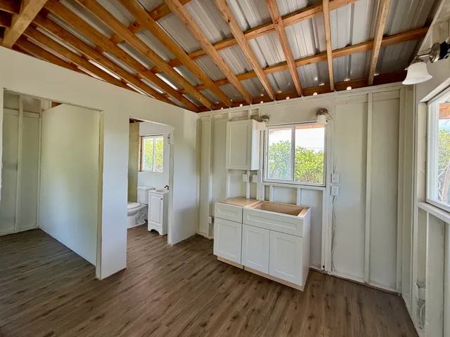 a very nice looking room with wooden floor and a balcony