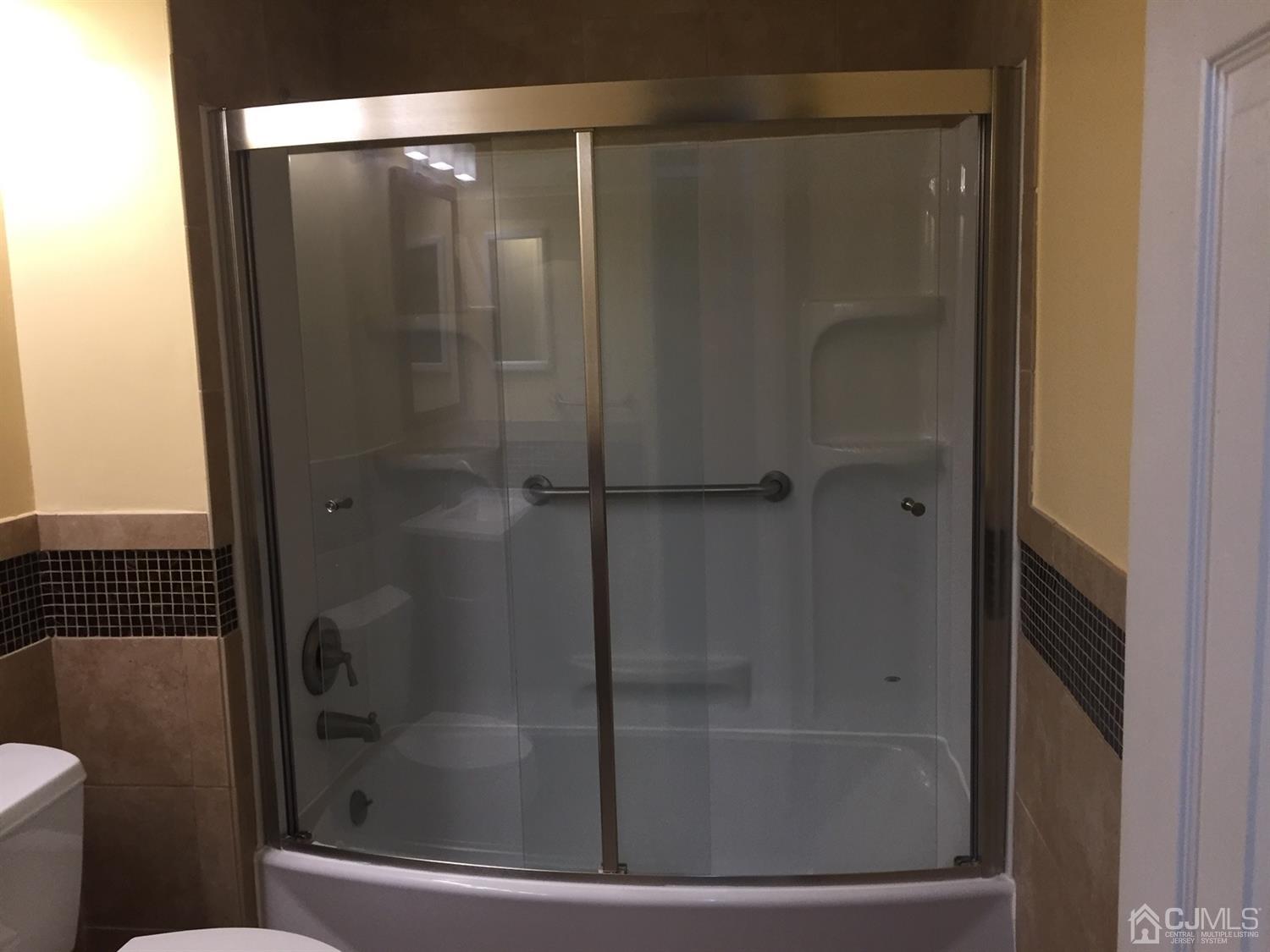 8201 Hana Road Edison, NJ 08817 - Photo 11 of 15 a bathroom with a glass shower door