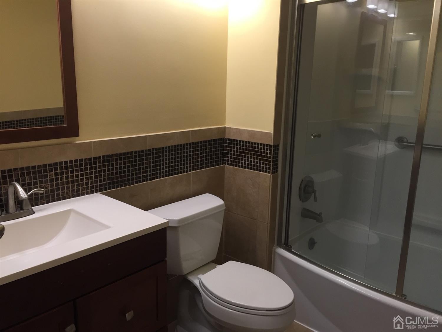 8201 Hana Road Edison, NJ 08817 - Photo 12 of 15 a bathroom with a sink a toilet and shower