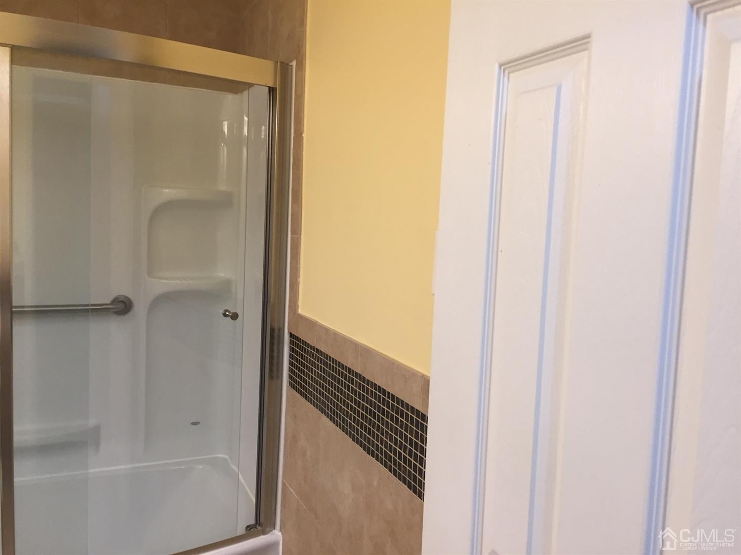 8201 Hana Road Edison, NJ 08817 - Photo 13 of 15 a bathroom with a glass shower door