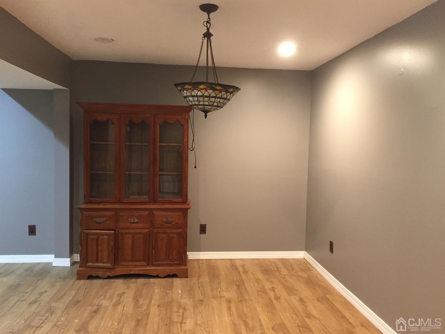 8201 Hana Road Edison, NJ 08817 - Photo 4 of 15 en view of a livingroom with a dishwasher cabinets and wooden floor