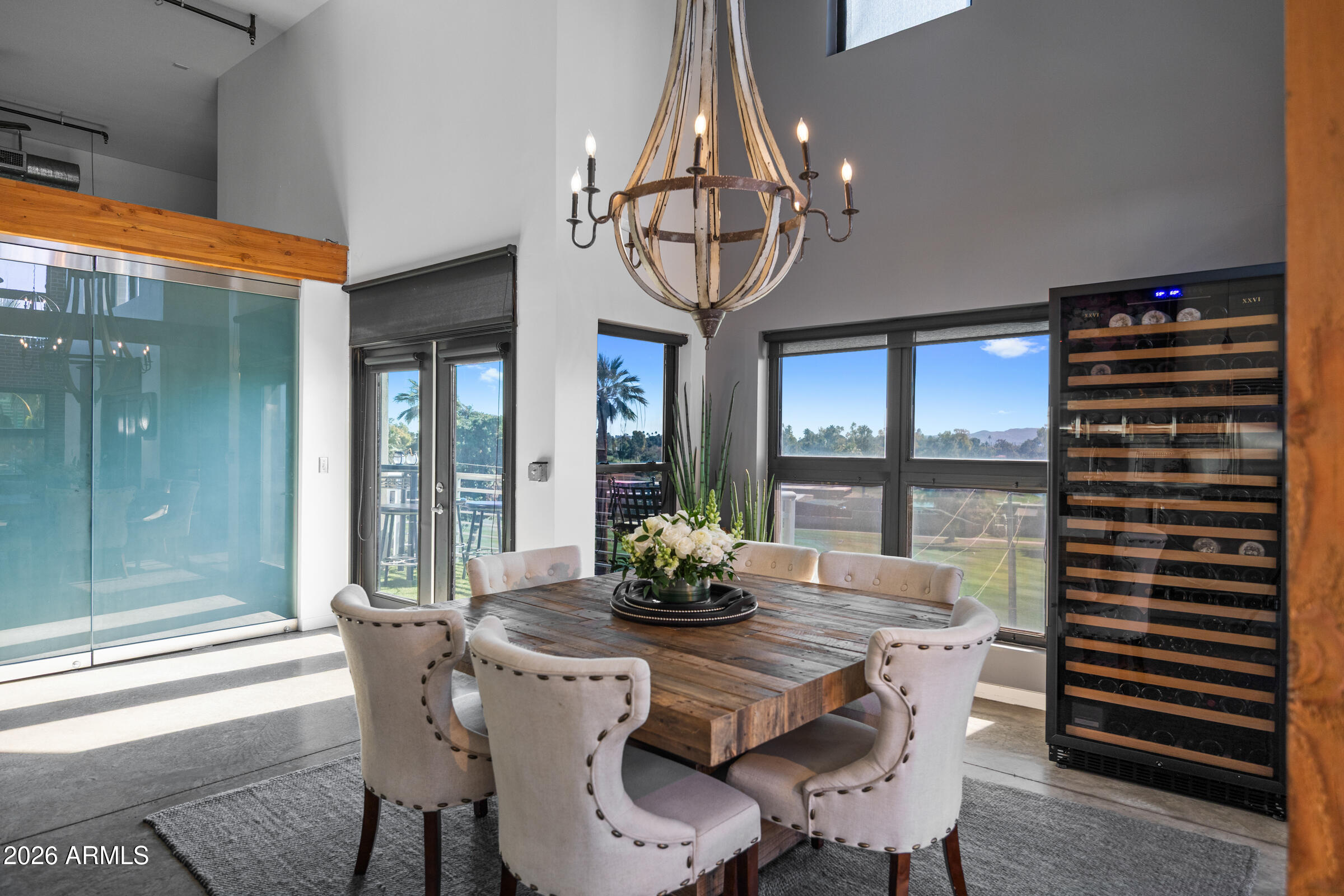 914 East Osborn Road, Unit 403 Phoenix, AZ 85014 - Photo 13 of 49 a dining room with furniture large windows and a chandelier