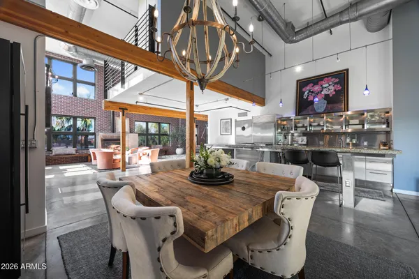 a view of a dining room with furniture wooden floor and chandelier