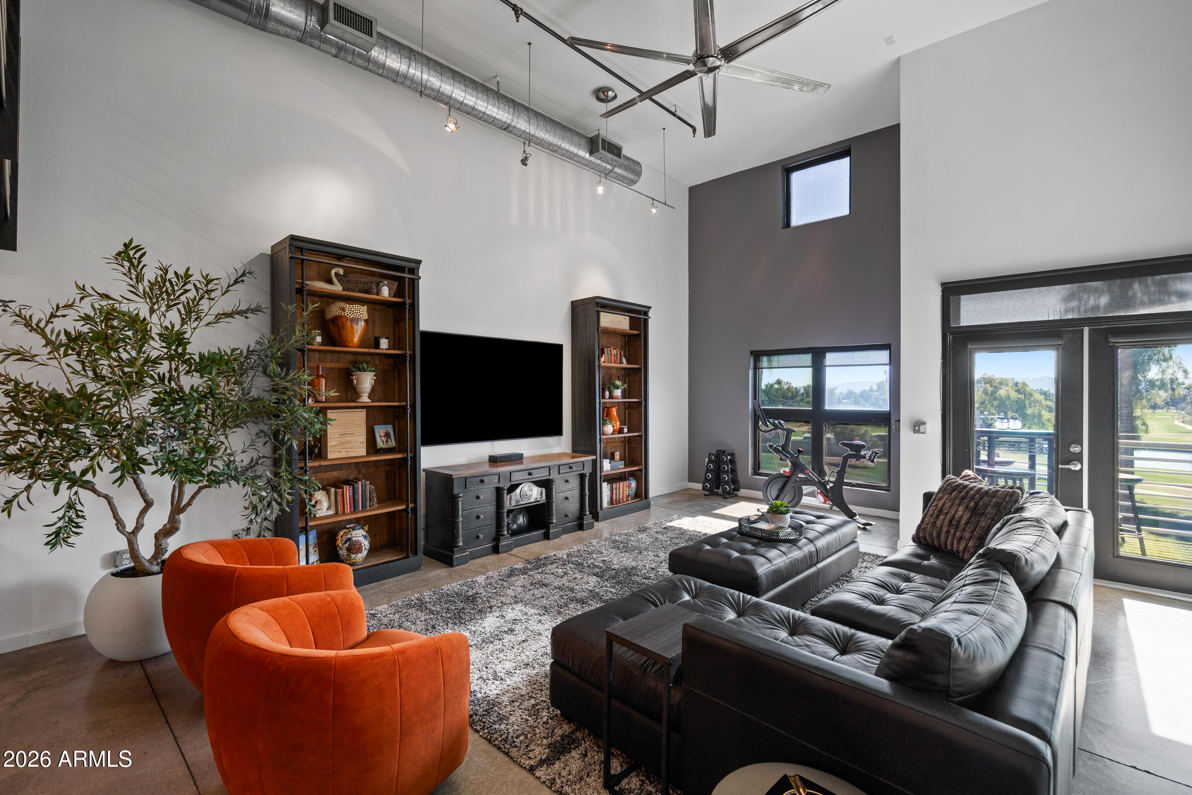 914 East Osborn Road, Unit 403 Phoenix, AZ 85014 - Photo 16 of 49 a living room with furniture a flat screen tv and a large window