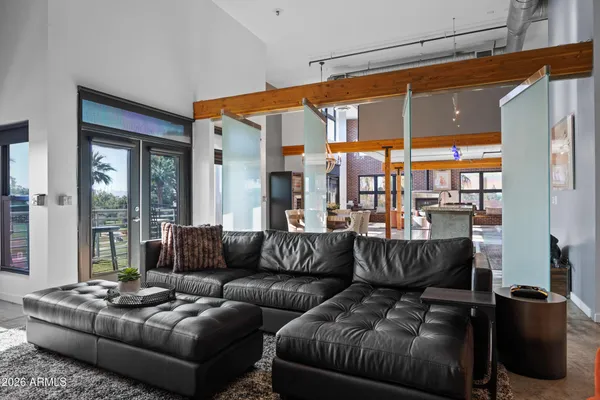 a living room with furniture a large window with outer view