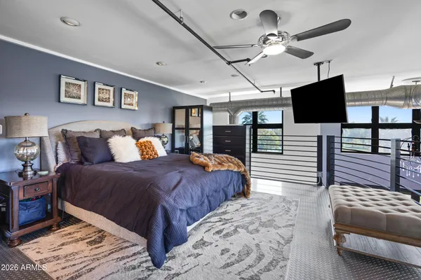 a bedroom with furniture and a flat screen tv