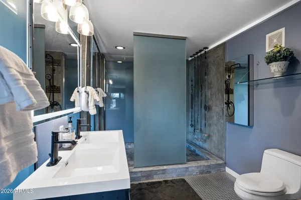 a bathroom with a double vanity sink and a mirror