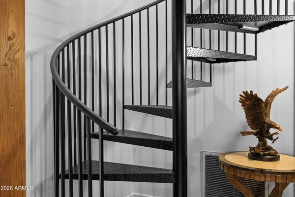 a bedroom with double bed and a flat tv screen on a dresser