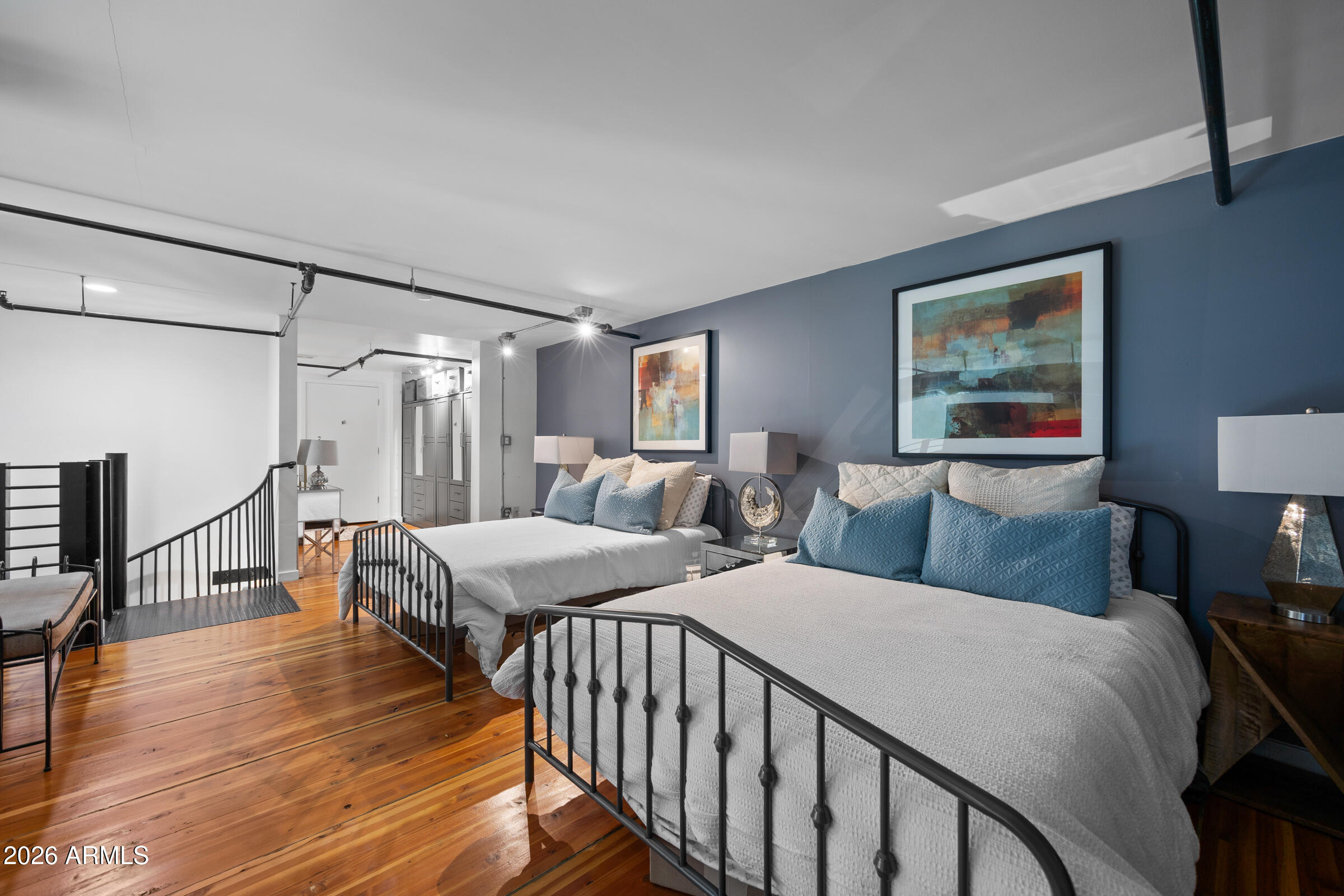 914 East Osborn Road, Unit 403 Phoenix, AZ 85014 - Photo 37 of 49 a bedroom with two beds and wooden floor