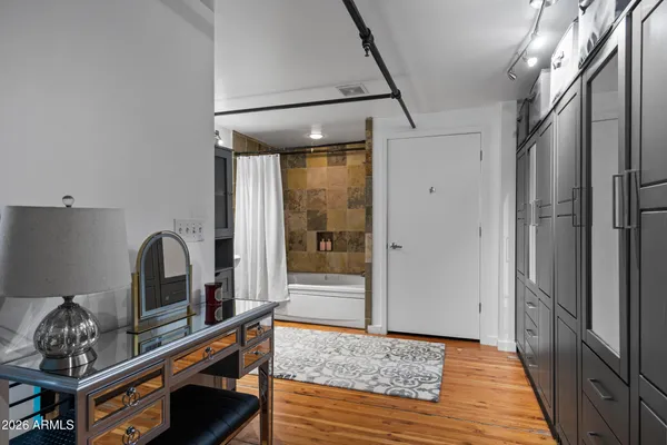 a bathroom with a sink a mirror with bathtub