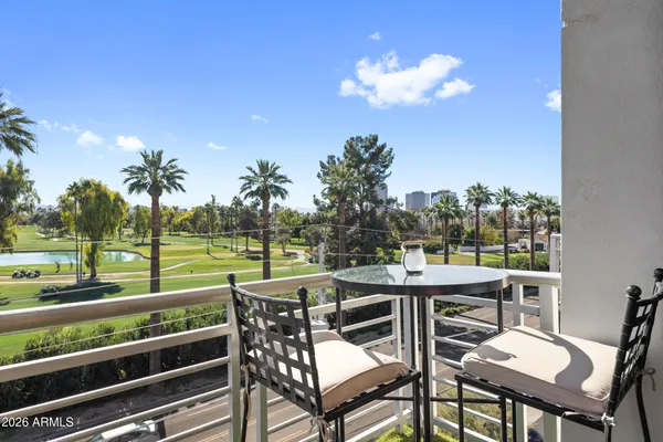 a view of a chairs and table in patio