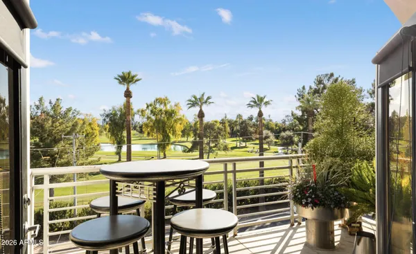an outdoor view from a balcony with furniture