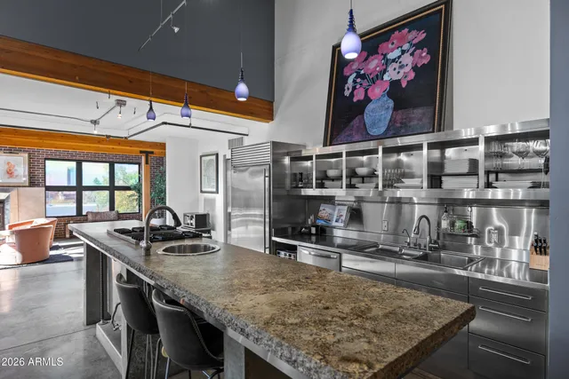 a kitchen with stainless steel appliances granite countertop a sink and a counter top space