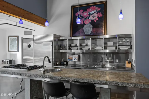 a kitchen with stainless steel appliances granite countertop a sink and a microwave