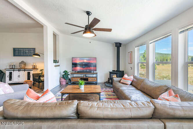 1015 Mountain Quail Road Calpine, CA 96124 - Photo 11 of 34 a living room with furniture and a flat screen tv