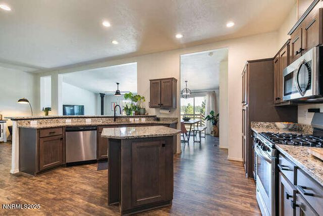 a kitchen with stainless steel appliances granite countertop a stove and cabinets