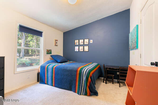 1015 Mountain Quail Road Calpine, CA 96124 - Photo 21 of 34 a bed room with a bed and a window