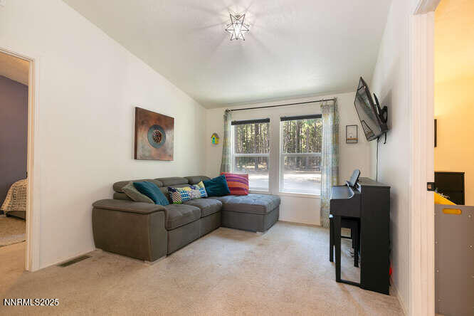 1015 Mountain Quail Road Calpine, CA 96124 - Photo 22 of 34 a living room with furniture and a window