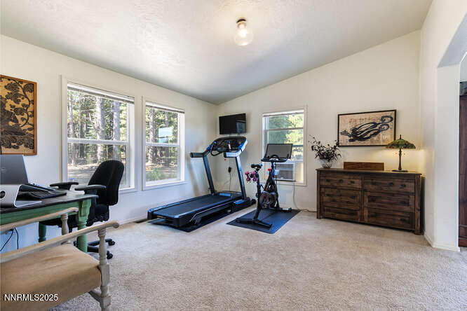 1015 Mountain Quail Road Calpine, CA 96124 - Photo 24 of 34 a view of a workspace with furniture and a window