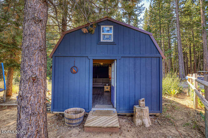 1015 Mountain Quail Road Calpine, CA 96124 - Photo 27 of 34 a brick house with table and chairs in front of it