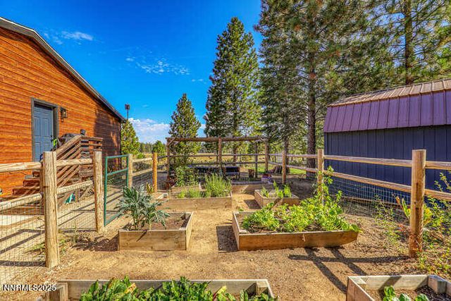 a view of a patio with table and chairs potted plants with wooden floor and seating space