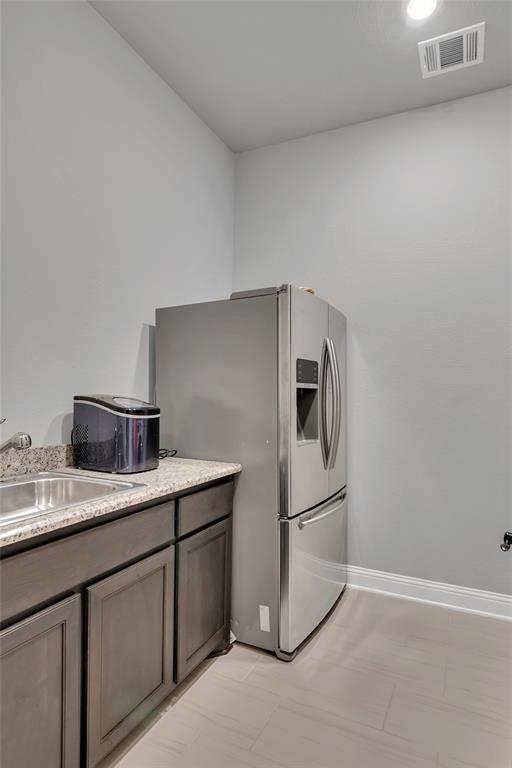 13753 Green Elm Road Fort Worth, TX 76008 - Photo 25 of 40 Laundry room has built-in cabinets with sink and room for refrigerator plus washer-dryer connections
