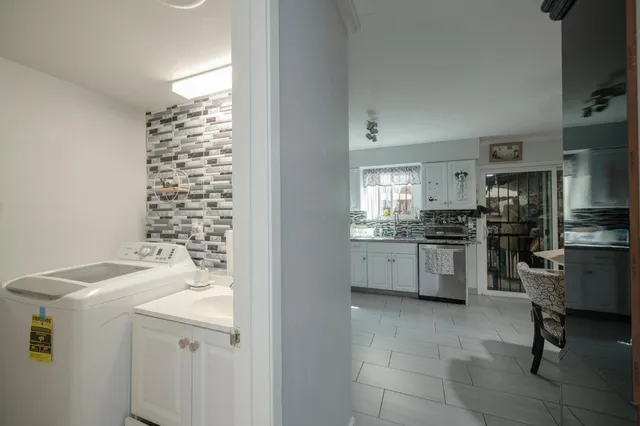 a kitchen with a sink a counter top space and stainless steel appliances