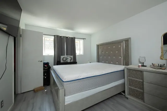 a bedroom with a bed and a dresser