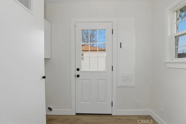 a view of empty room with windows and ceiling fan