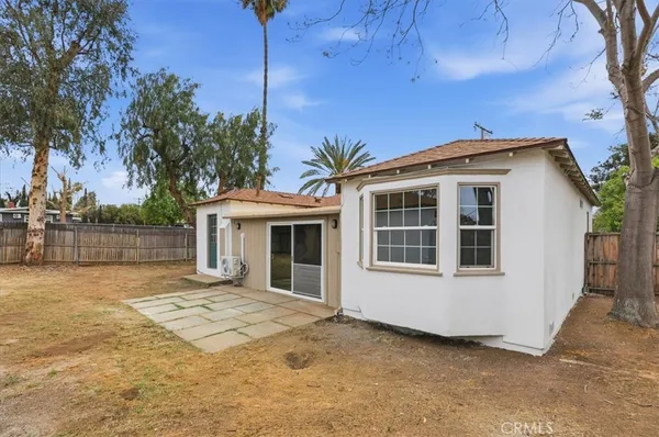 a house that has a tree in front of it