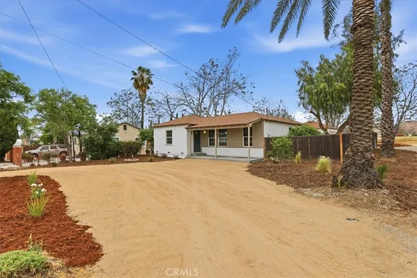 a view of a house with a tree in the background