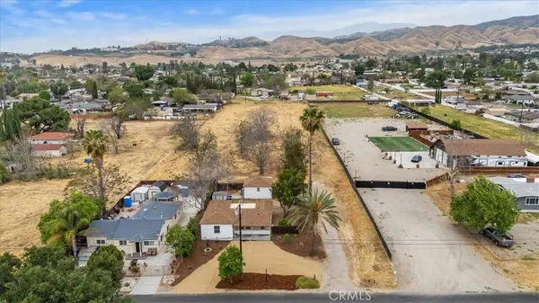 an aerial view of residential houses with outdoor space and river