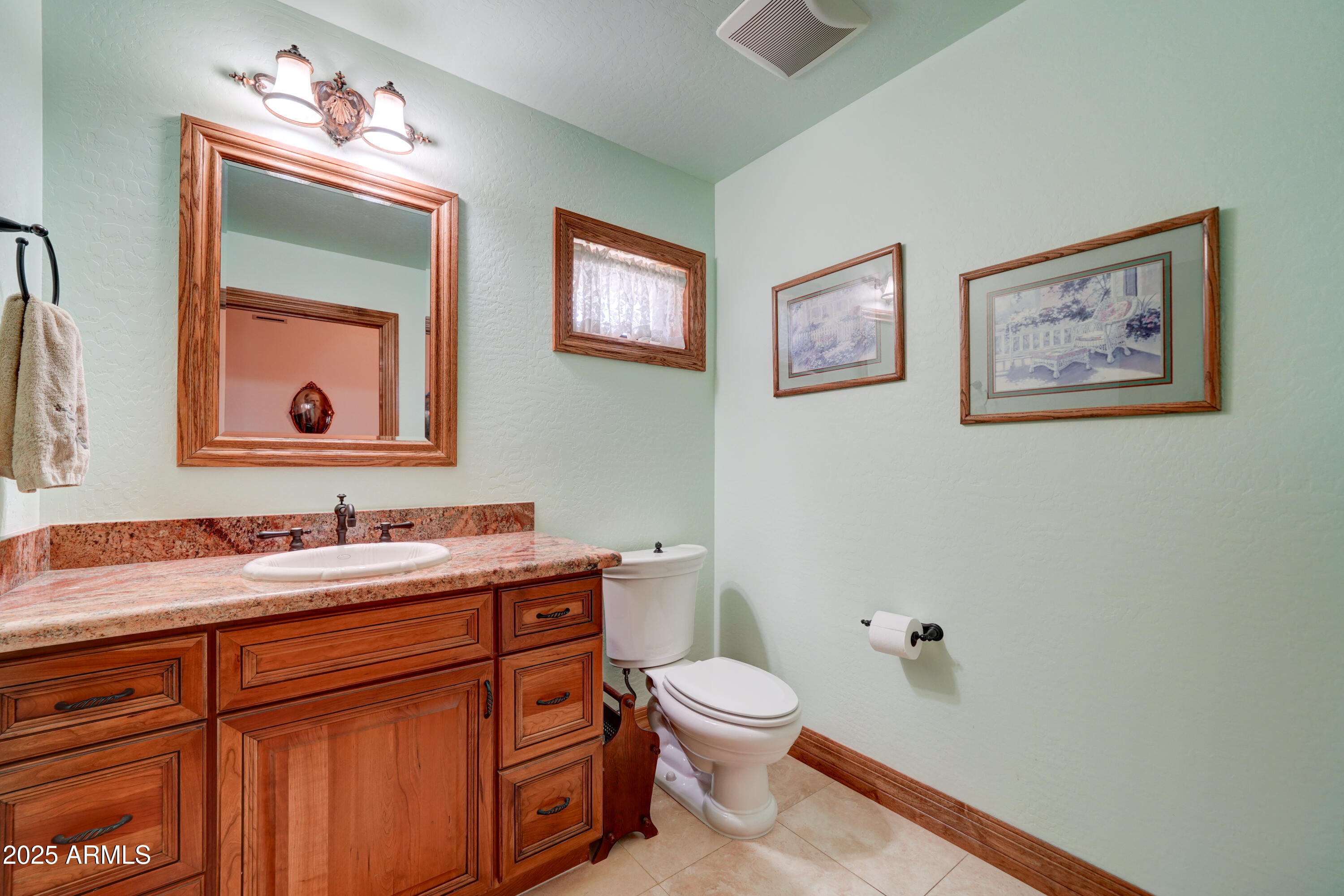 424 East Lehi Road, Unit 2 Mesa, AZ 85203 - Photo 24 of 39 a bathroom with a toilet sink and mirror
