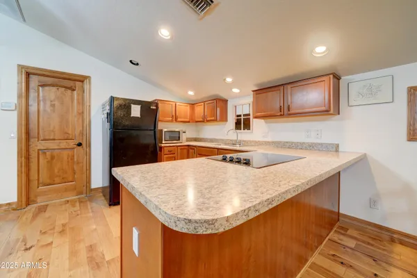 a kitchen with stainless steel appliances granite countertop a sink refrigerator and microwave